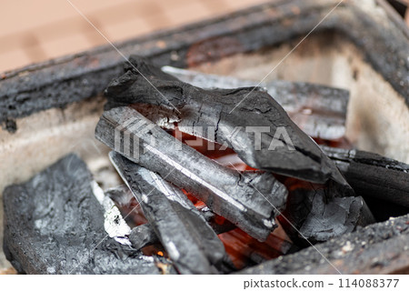 Burning charcoal Burning charcoal 114088377