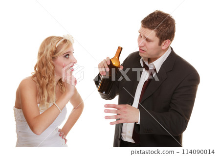 Wedding couple, bride with alcoholic drinking groom. Wedding couple, bride with alcoholic drinking groom. 114090014