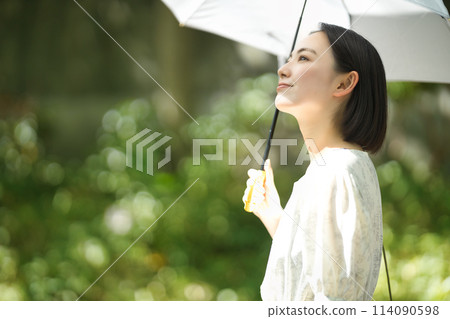 A young woman holding a parasol 114090598