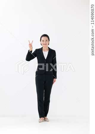 Business middle-aged woman standing pose peace sign Business middle-aged woman standing pose peace sign 114090870