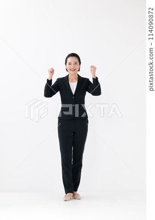 Business middle-aged woman standing fist pump 114090872