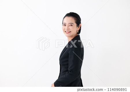 Business middle-aged woman, arms crossed, turning around Business middle-aged woman, arms crossed, turning around 114090891