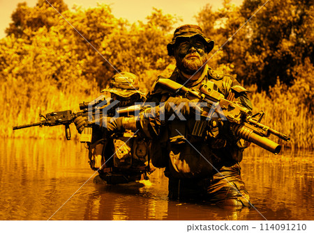 Soldiers move in the heart of a marsh, crossing swampy waters, tropical jungle heat, extreme conditions of concealed tactical combat operations of special task forces Soldiers move in the heart of a marsh, crossing swampy waters, tropical jungle heat, extreme conditions of concealed tactical combat operations of special task forces 114091210