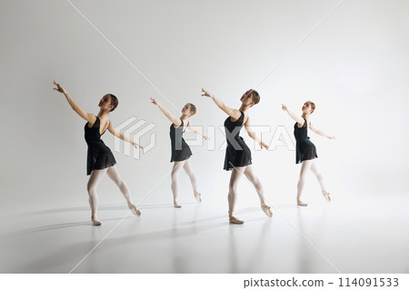 Beauty of ballet dance. Elegant teen girls, ballerinas in black leotards training, practicing against grey studio background. 114091533