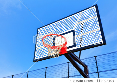 Image of a basketball goal and blue sky 114092405