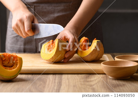 Organic pumpkin cutting on wooden board, Homemade cooking, Food ingredient Organic pumpkin cutting on wooden board, Homemade cooking, Food ingredient 114093050