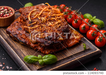 Delicious pork or beef ribs baked on the grill with salt, spices and herbs Delicious pork or beef ribs baked on the grill with salt, spices and herbs 114093740