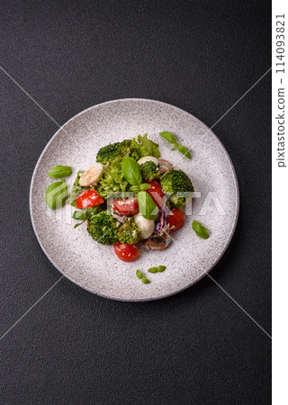 Delicious fresh juicy salad with quail eggs, cherry tomatoes, lettuce leaves 114093821