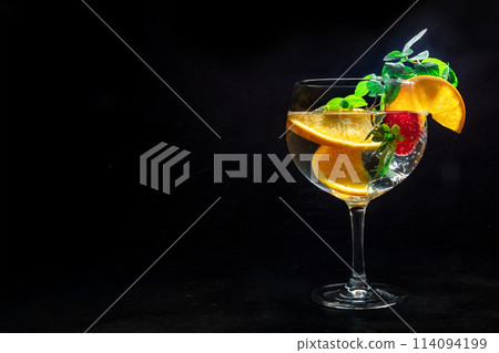 Fancy cocktail with fresh fruit. Gin and tonic drink with ice at a party 114094199
