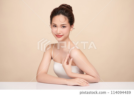 Beautiful young asian woman with clean fresh skin on beige background, Face care, Facial treatment, Cosmetology, beauty and spa, Asian women portrait. Beautiful young asian woman with clean fresh skin on beige background, Face care, Facial treatment, Cosmetology, beauty and spa, Asian women portrait. 114094489