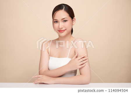 Beautiful young asian woman with clean fresh skin on beige background, Face care, Facial treatment, Cosmetology, beauty and spa, Asian women portrait. Beautiful young asian woman with clean fresh skin on beige background, Face care, Facial treatment, Cosmetology, beauty and spa, Asian women portrait. 114094504