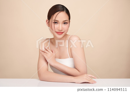 Beautiful young asian woman with clean fresh skin on beige background, Face care, Facial treatment, Cosmetology, beauty and spa, Asian women portrait. 114094511