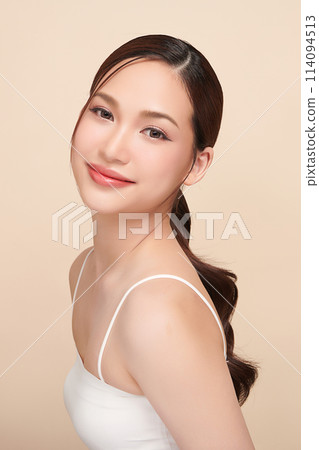 Beautiful young asian woman with clean fresh skin on beige background, Face care, Facial treatment, Cosmetology, beauty and spa, Asian women portrait. Beautiful young asian woman with clean fresh skin on beige background, Face care, Facial treatment, Cosmetology, beauty and spa, Asian women portrait. 114094513