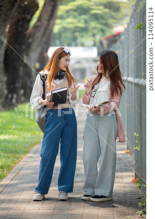 University student girl friends with learning book college while walking in campus University student girl friends with learning book college while walking in campus 114095114