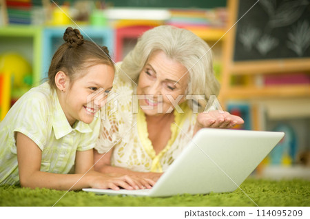 Portrait of grandmother and daughter using laptop Portrait of grandmother and daughter using laptop 114095209