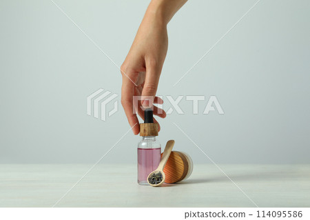 Lavender oil in a bottle on a light background Lavender oil in a bottle on a light background 114095586