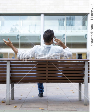 Man on phone with expressive gesture 114095708