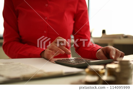Worker counting with calculator indoor Worker counting with calculator indoor 114095999