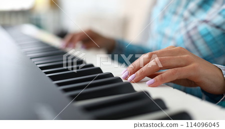 Pretty woman giving lesson to play piano Pretty woman giving lesson to play piano 114096045