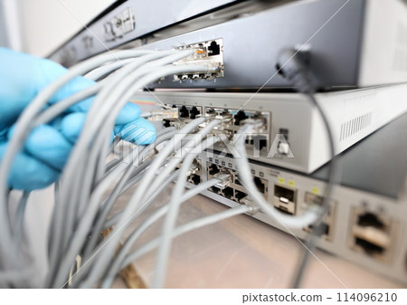 Male technician hand in blue protective glove connects 114096210