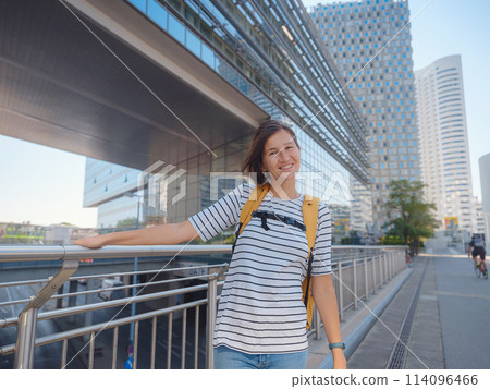Female tourist traveling in Austria, capital city Vienna. summer female solo trip to Europe, happy young woman walking in Donaustadt district street Female tourist traveling in Austria, capital city Vienna. summer female solo trip to Europe, happy young woman walking in Donaustadt district street 114096466