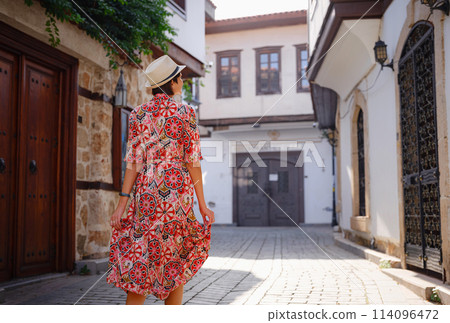 female summer travel to Antalya, Turkey. young asian woman in red dress walk through old town Kalechi , female tourist traveler discover interesting places and popular tourist attraction female summer travel to Antalya, Turkey. young asian woman in red dress walk through old town Kalechi , female tourist traveler discover interesting places and popular tourist attraction 114096472