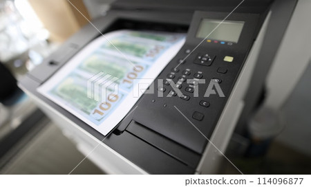 Sheet of paper printed on a printer with fake dollars 114096877
