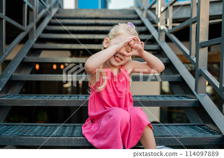 Child with hearing problem and cochlear implant plays in street, deaf kid began to hear. Hearing loss in childhood and treatment concept. Inclusion and disability. Child with hearing problem and cochlear implant plays in street, deaf kid began to hear. Hearing loss in childhood and treatment concept. Inclusion and disability. 114097889