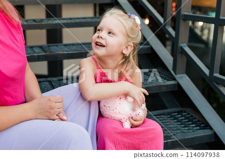 Child girl with cochlear implant with her mother spend time outdoor. Hear impairment and deaf community concept. Deaf and health concept. Disability and inclusion. Copy space Child girl with cochlear implant with her mother spend time outdoor. Hear impairment and deaf community concept. Deaf and health concept. Disability and inclusion. Copy space 114097938