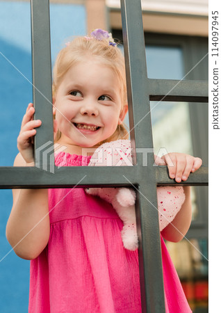 Happy cute child girl having fun outdoor in summer time. Children and generation alpha concept 114097945