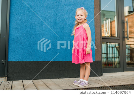 Child girl with hearing aids and cochlear implants having fun outdoor speak and playing. Inclusion and disability. 114097964