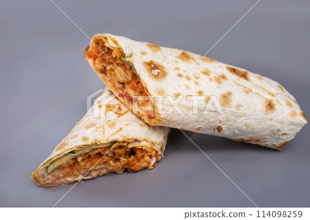 shaurma with chicken and vegetables on a gray background 114098259