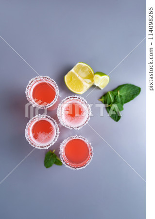 set of four pink cocktails with lime and mint top view 114098266