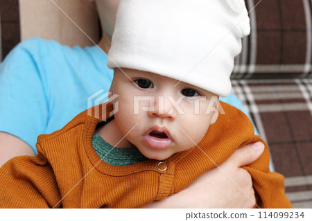 Happy family together on a walk in the outdooron a Sunny summer day. A caring mother holds her young son in her arms 114099234