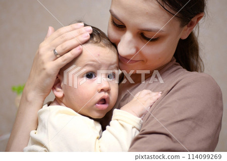 Pretty young mother holding her newborn baby boy. close up Pretty young mother holding her newborn baby boy. close up 114099269