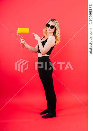 Young minded employee laborer handyman woman choosing roller brush paint Young minded employee laborer handyman woman choosing roller brush paint 114099378
