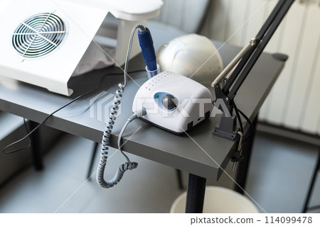 Electric manicure machine on table. Drill for manicure 114099478