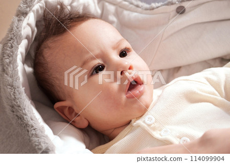 A mother dressing her little baby boy boy at home. childhood parenthood and growing up family concept real people A mother dressing her little baby boy boy at home. childhood parenthood and growing up family concept real people 114099904