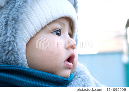 Happy little baby boy making outdoors in winter. Cute toddler in winter cloth. Child having fun on cold day. Winter walk outdoors 114099906