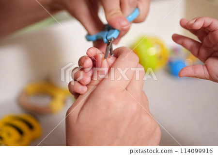 Cutting baby nails. Baby care, closed up shot of newborn nails clipping 114099916