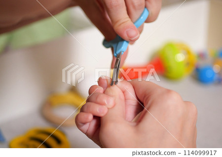 Cutting baby nails. Baby care, closed up shot of newborn nails clipping Cutting baby nails. Baby care, closed up shot of newborn nails clipping 114099917