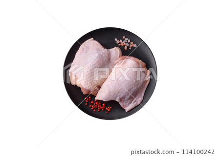 Fresh raw chicken thighs with salt and spices 114100242