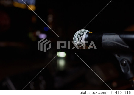 Microphone on stand before crowd, part of public address system at event 114101116