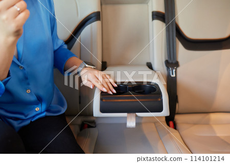female hand opens the Cup holder in the car 114101214