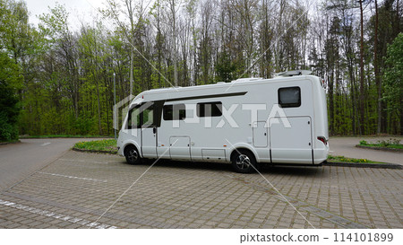 The one white modern campervan recreational motor home parked at road. Motorhome campground stataion travel destination. RV lifestyle 114101899