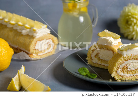 Lemon roll with fruit curd, with mint, close-up. On a gray background 114103137