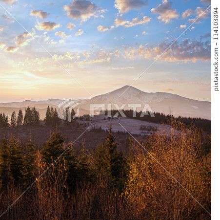 Picturesque sunrise above late autumn mountain countryside.  Ukraine, Carpathian Mountains. Peaceful traveling, seasonal, nature and countryside beauty concept scene. 114103894