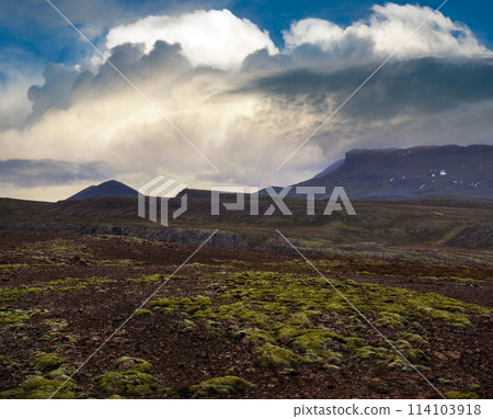 View during auto trip in West Iceland highlands, Snaefellsnes peninsula, Snaefellsjokull National Park. Spectacular volcanic tundra landscape with mountains, craters, lakes, gravel roads. 114103918