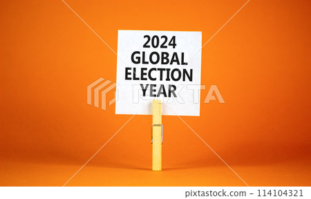 2024 global election year symbol. Concept words 2024 global election year on beautiful white paper on clothespin. Beautiful orange background. Business 2024 global election year concept. Copy space 2024 global election year symbol. Concept words 2024 global election year on beautiful white paper on clothespin. Beautiful orange background. Business 2024 global election year concept. Copy space 114104321