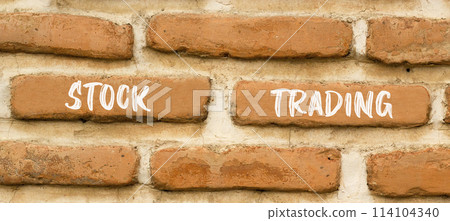 Stock trading symbol. Concept words Stock trading on beautiful brown brick wall. Beautiful brown brick wall background. Business stock trading concept. Copy space. 114104340